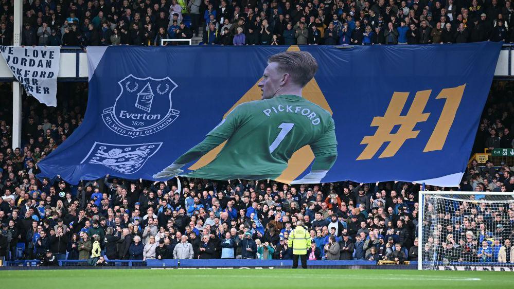 Everton fans in the in the Gwladys Street End raise a huge banner in homage to Jordan Pickford before kick-off.