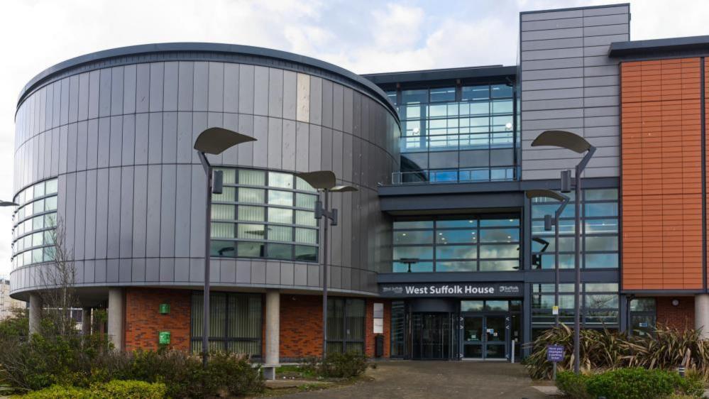 A picture of the building of West Suffolk council. It is a mixture of red bricks and glass. 