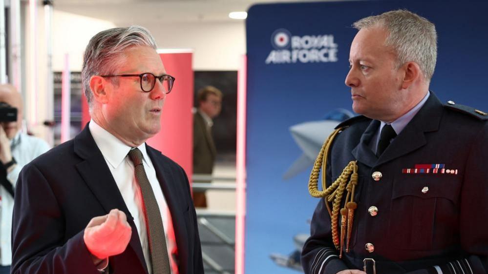 Prime Minister Sir Keir Starmer (left) speaks with Air Chief Marshal Richard Knighton (second right) during a visit to a defence contractor in Bedfordshire