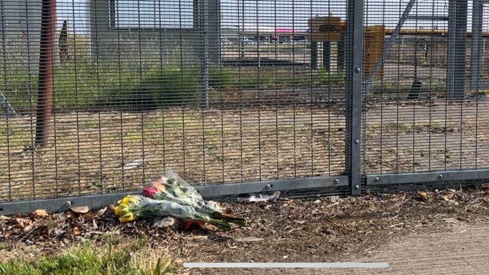 Flowers were laid by the perimeter fence at Gatwick on Friday.