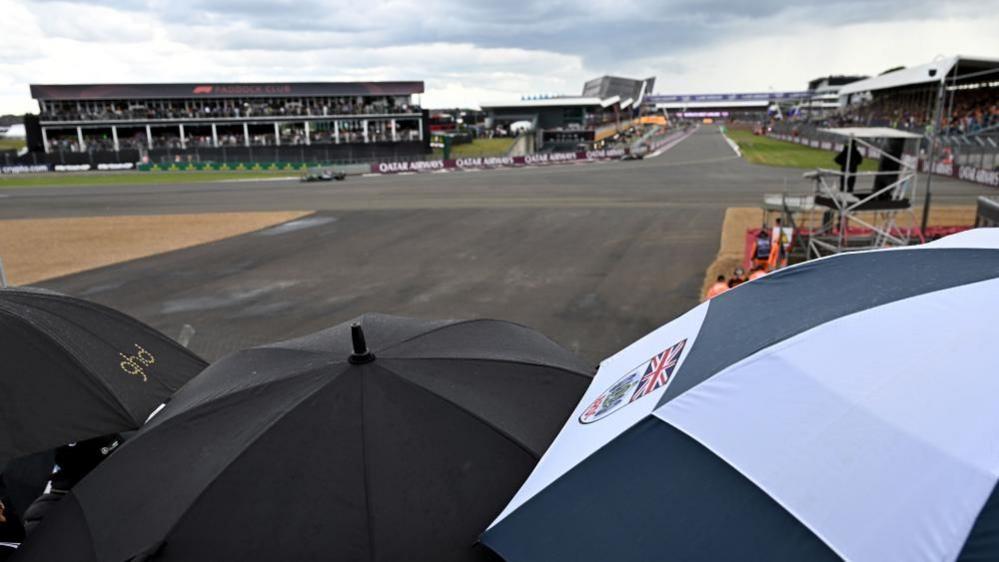 Fans with umbrellas at Silverstone