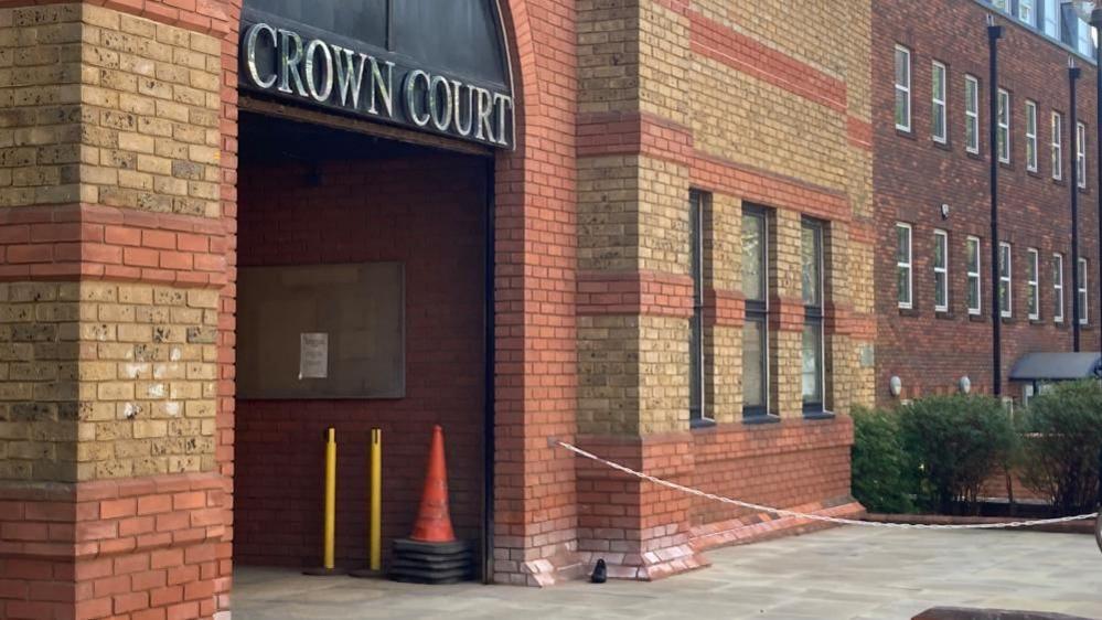 St Albans Crown Court: A red-and-yellow-brick building with the words "CROWN COURT" written in silver above the entrance.