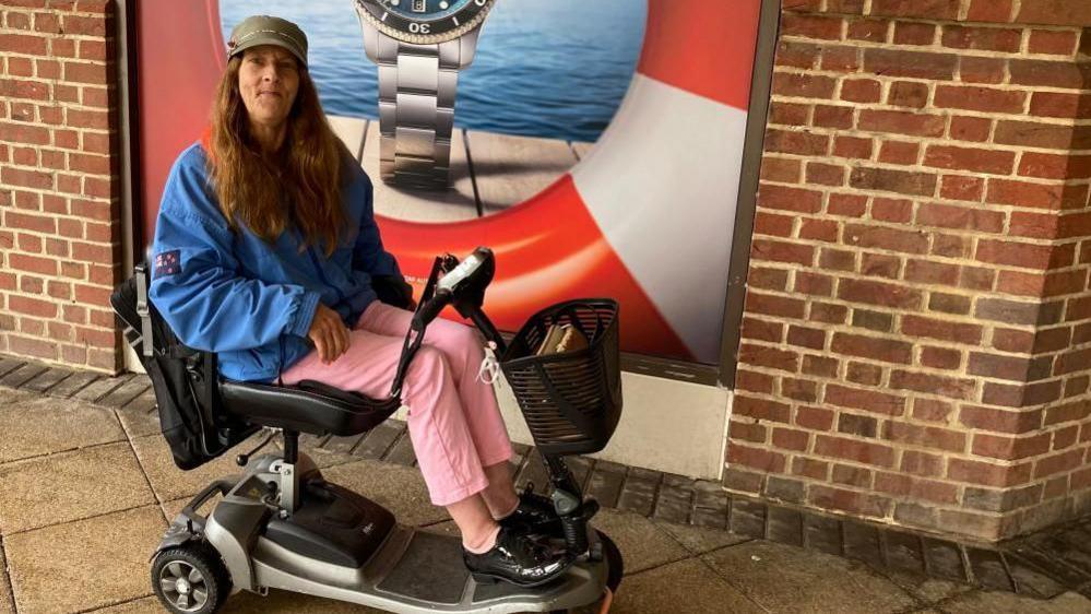 Sarah Gates sitting on a mobility scooter