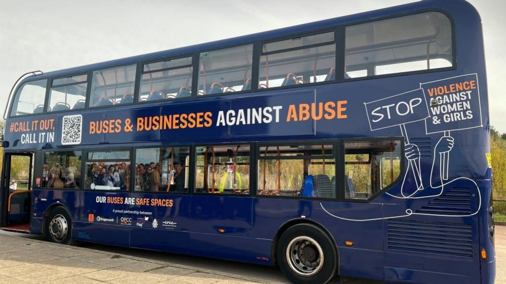 A blue Stagecoach bus with Call it out, Call it in, Buses & Businesses against Abuse and Stop Violence Against Women & Girls written across it. 