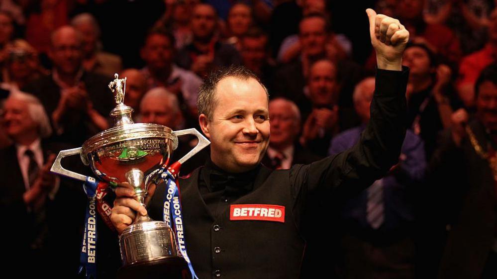 John Higgins holding the World Championship trophy