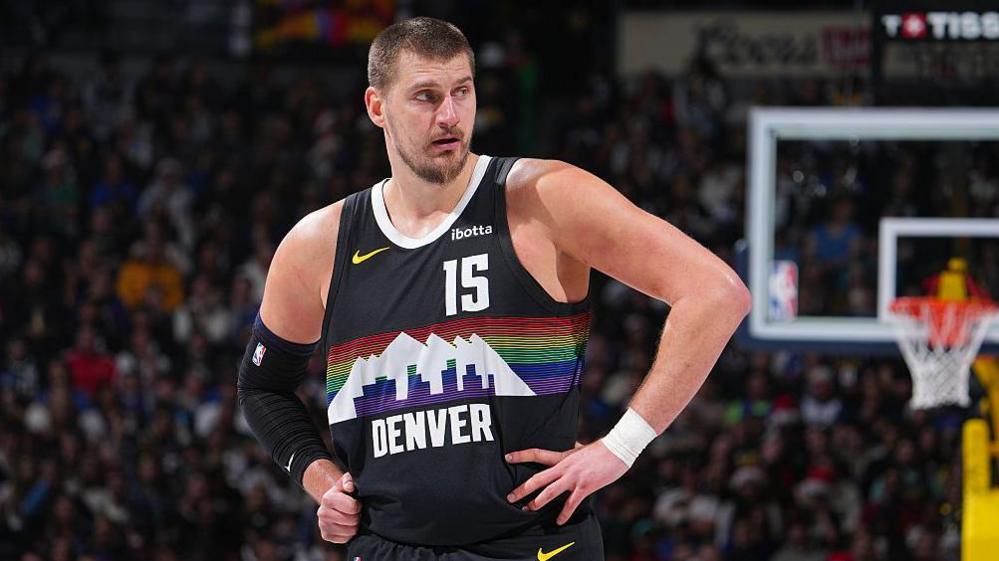 Nikola Jokic stood with his hands on his hips while playing for the Denver Nuggets