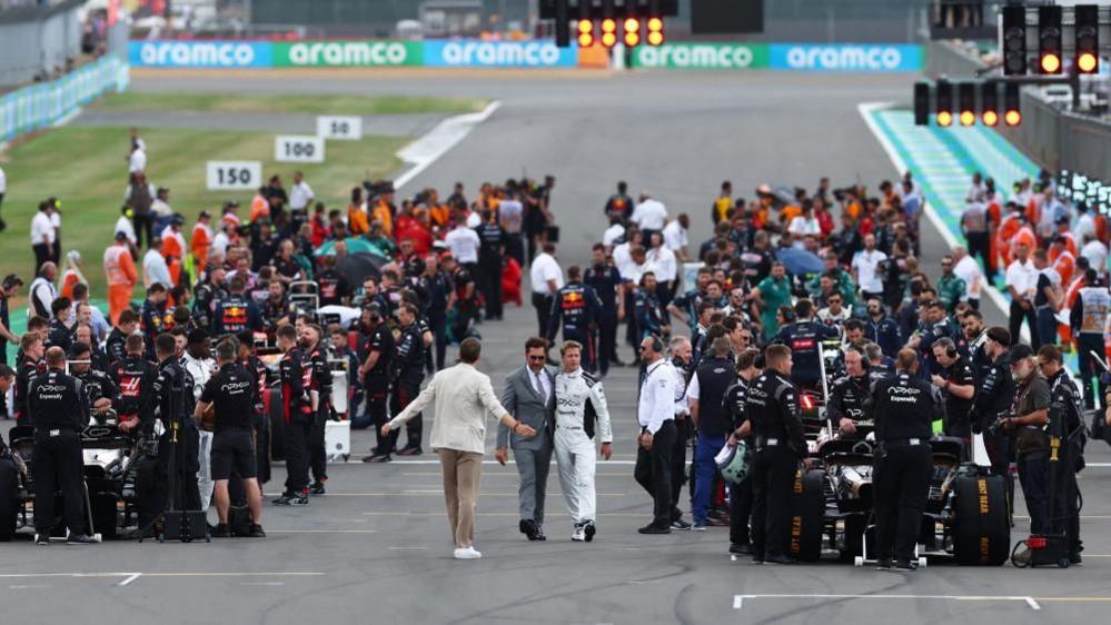 Javier Bardem and Brad Pitt on the British Grand Prix grid