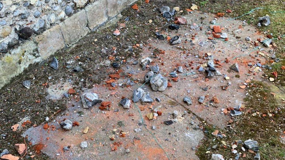A number of stones and remnants of bricks on a stone plinth outside Great Yarmouth Minster, which had been thrown at windows.