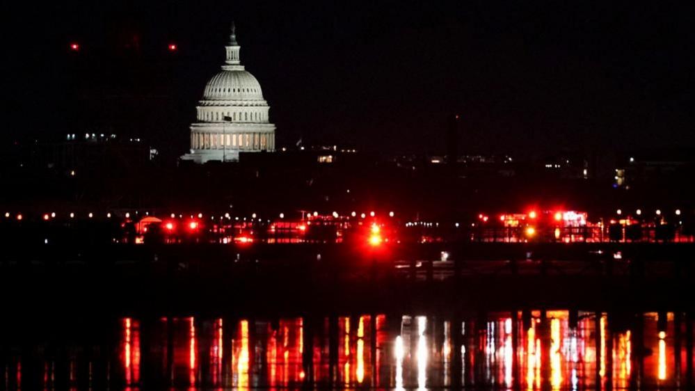 Emergency services at work on the Potomac River with the US Capitol building behind