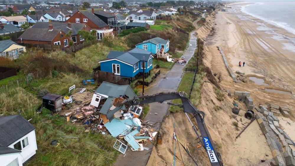 Drone image of The Marrams in Hemsby with houses being demolished by a long-reach digger.