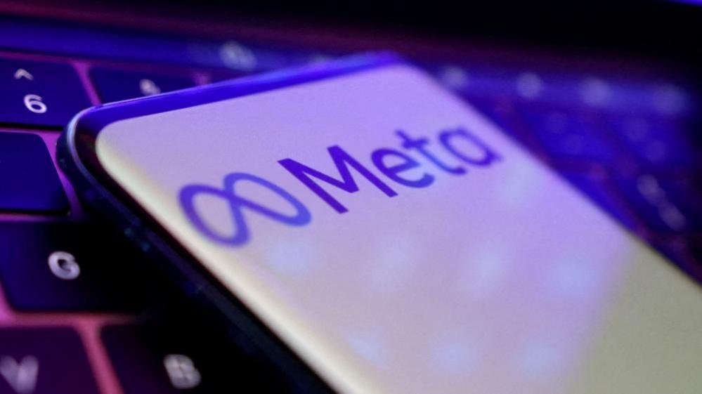 The Meta logo is visible against a white backdrop on a smartphone