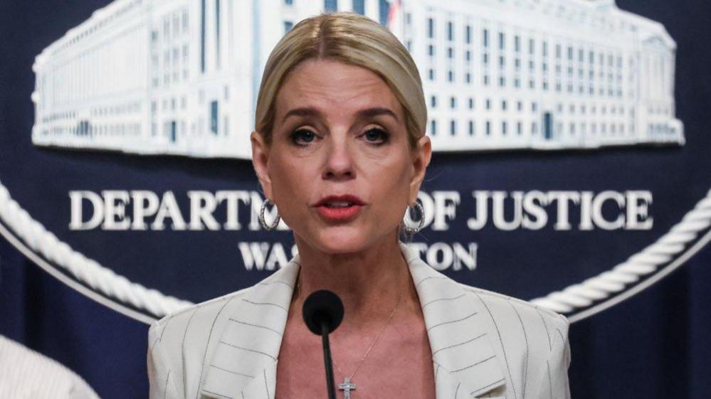 Woman stands in front of microphone