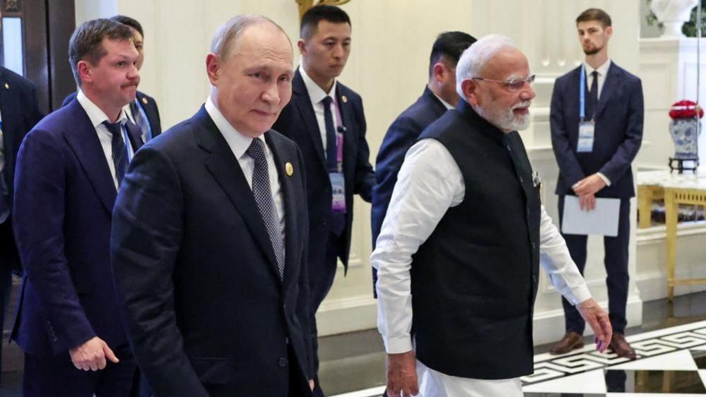 Russian President Vladimir Putin and Indian Prime Minister Narendra Modi walk during their meeting on the sidelines of the Shanghai Cooperation Organisation (SCO) summit in Tianjin, China on 1 September, 2025.