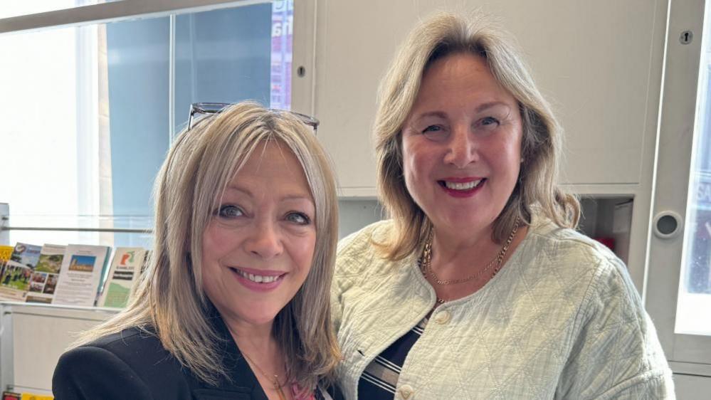 Sue and Val, both with long blond hair, smiling