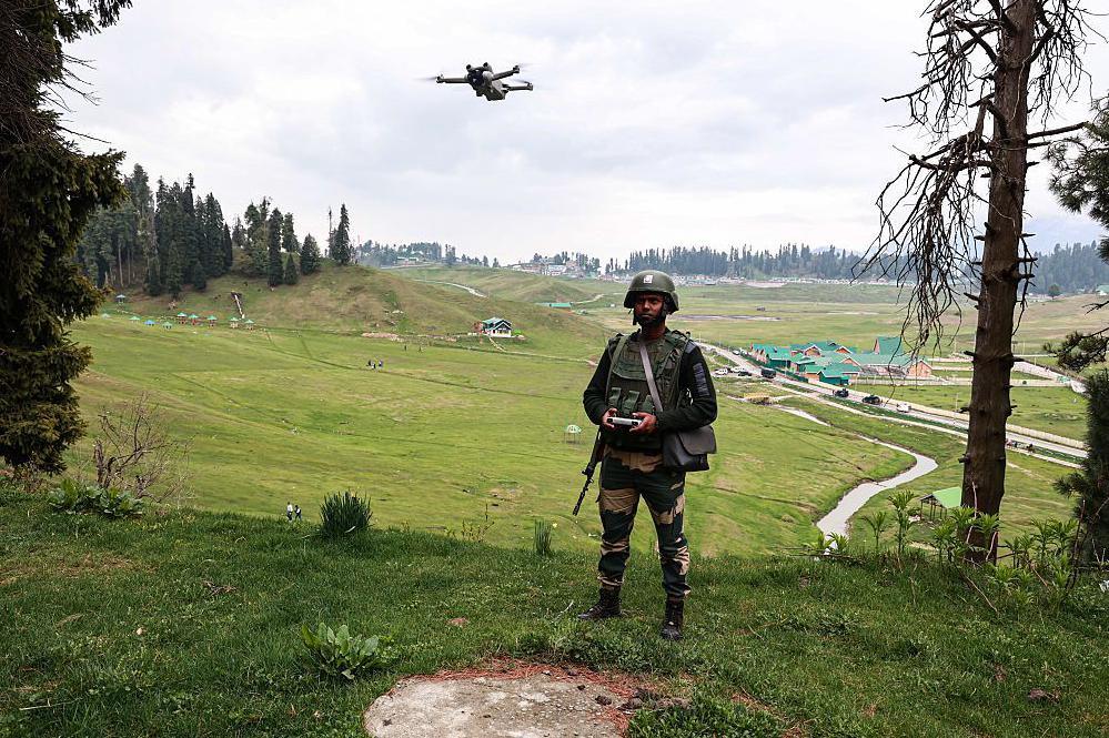 An Indian soldier of the border security forces keeps vigil while using a drone in Gulmarg, Jammu and Kashmir, India, on May 3, 2025.