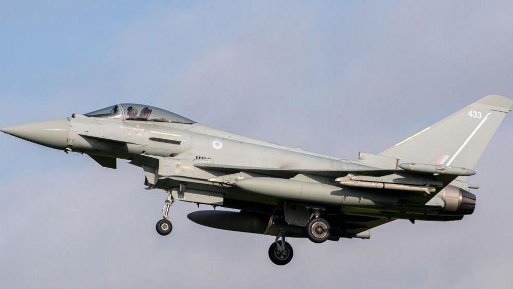 Royal Air Force Eurofighter Typhoon coming into land at RAF Coningsby. It has the number 433 on the tail fin and the RAF's red, white and blue circular emblem behind the cockpit. 