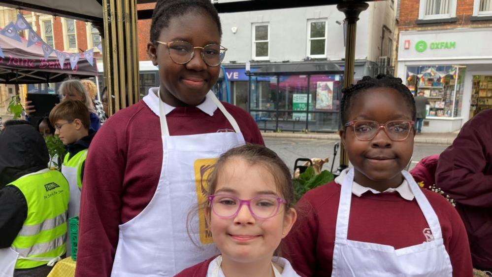 Three children from Cauldwell School, Bedford, at Bedford Market 