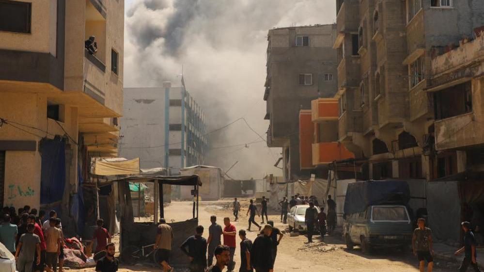 Smoke billows from an evacuated UNRWA school following Israeli airstrikes, at al-Shati (Beach) refugee camp, in Gaza City, September 13