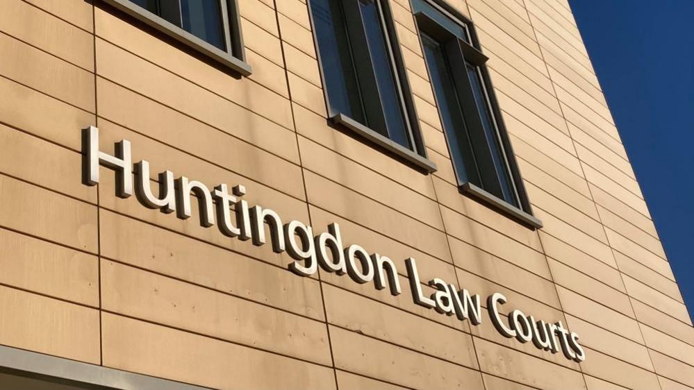 The words "Huntingdon Law Courts" written in silver on the side of a yellow building