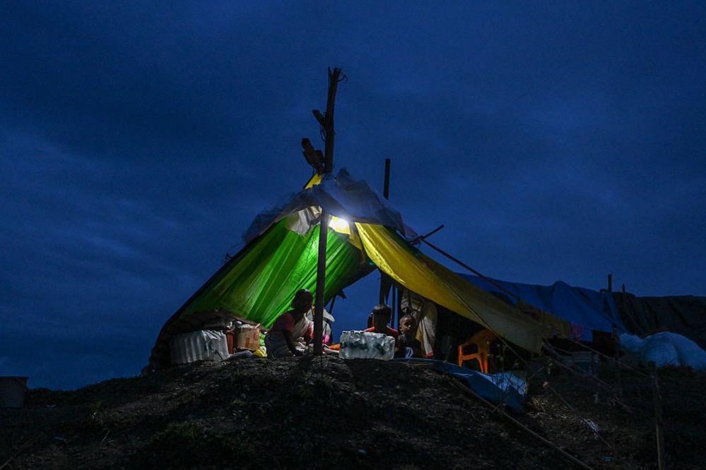  Flood affected residents shelter inside a temporary tent after being displaced by flooding on August 4, 2026 in Sivasagar district, Assam, India.