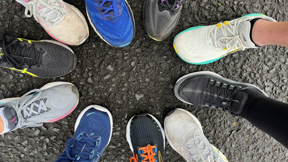 10 running shoes joined together in a circle.