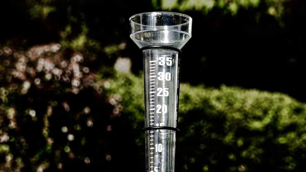 A rain gauge showing numbers