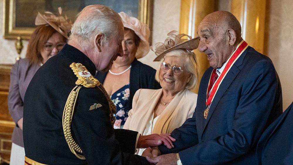 Sir Billy Boston talking to King Charles III.