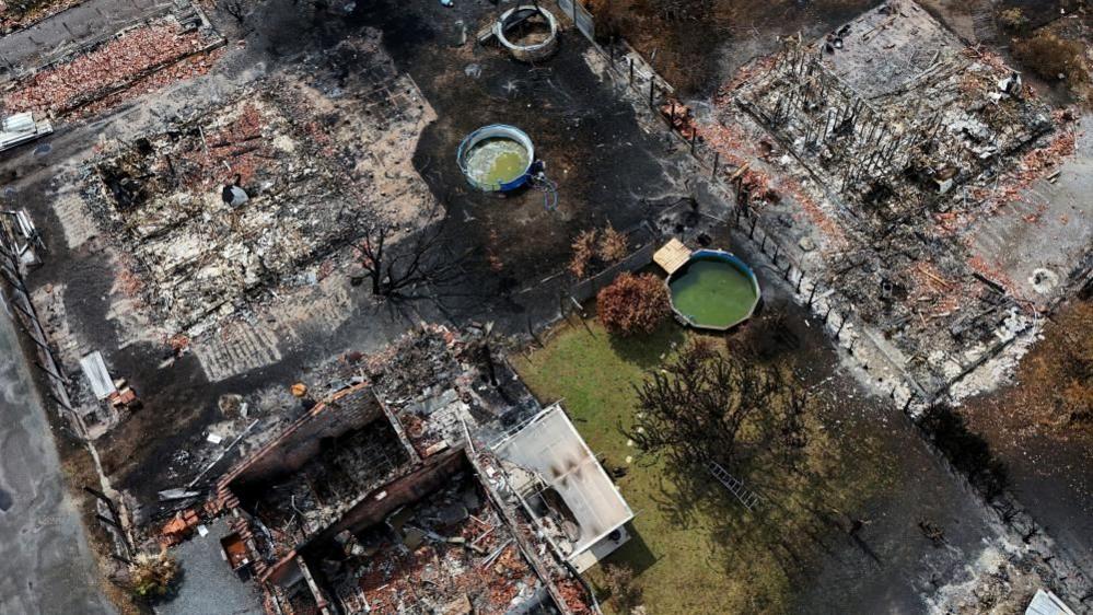 A drone view of buildings destroyed by a wildfire in Le Porge