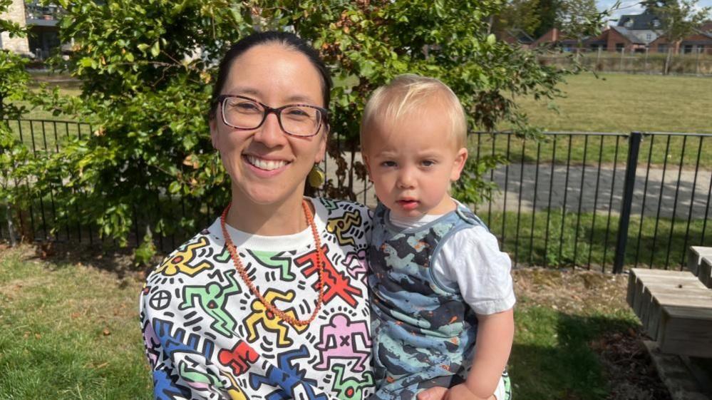 Sophia and her son who are moving into York's community housing scheme Yorspace, are looking straight at the camera. Fiona is smiling and has dark hair in a ponytail. Her son has blond hair and is wearing a blue T-shirt.