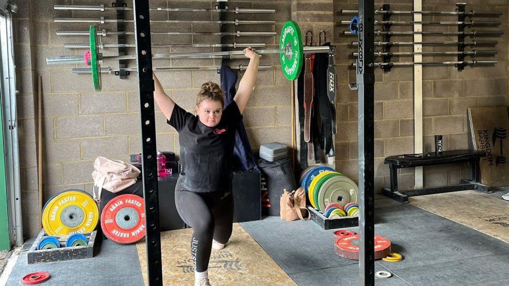 Stevie lifting weights on a bar