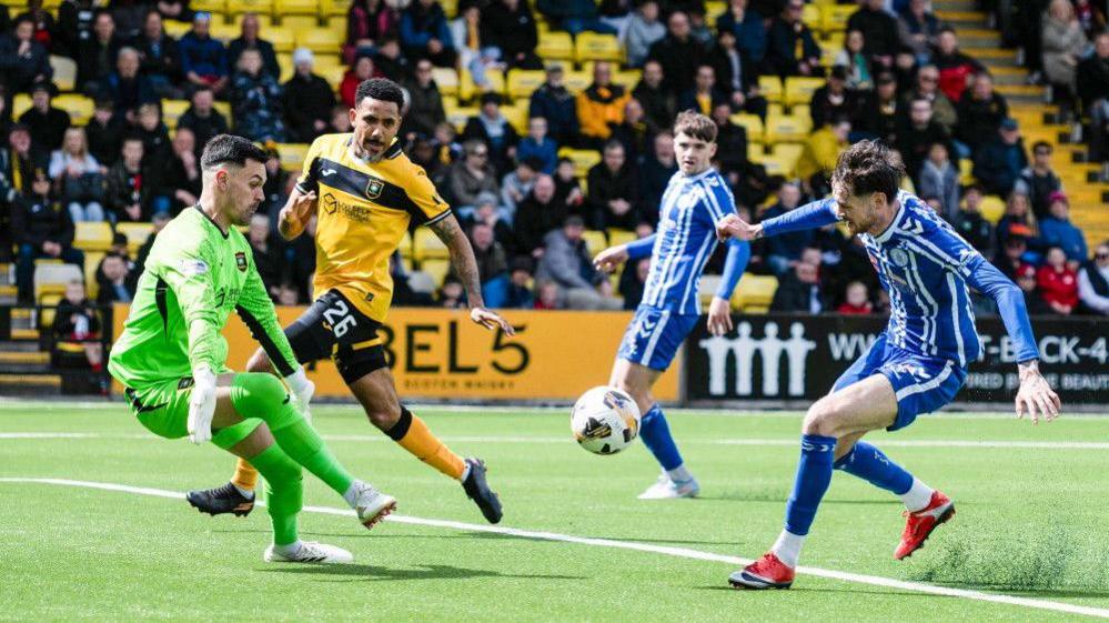 Joe Hugill slips the ball past Jerome Prior