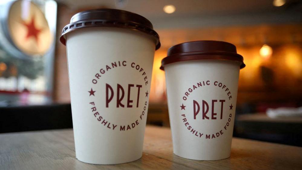 Shot showing two Pret A Manger coffee cups 