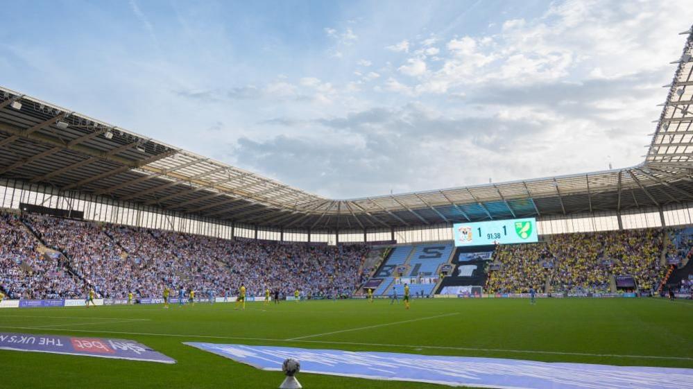 Large football stadium from the pitch looking towards the stands