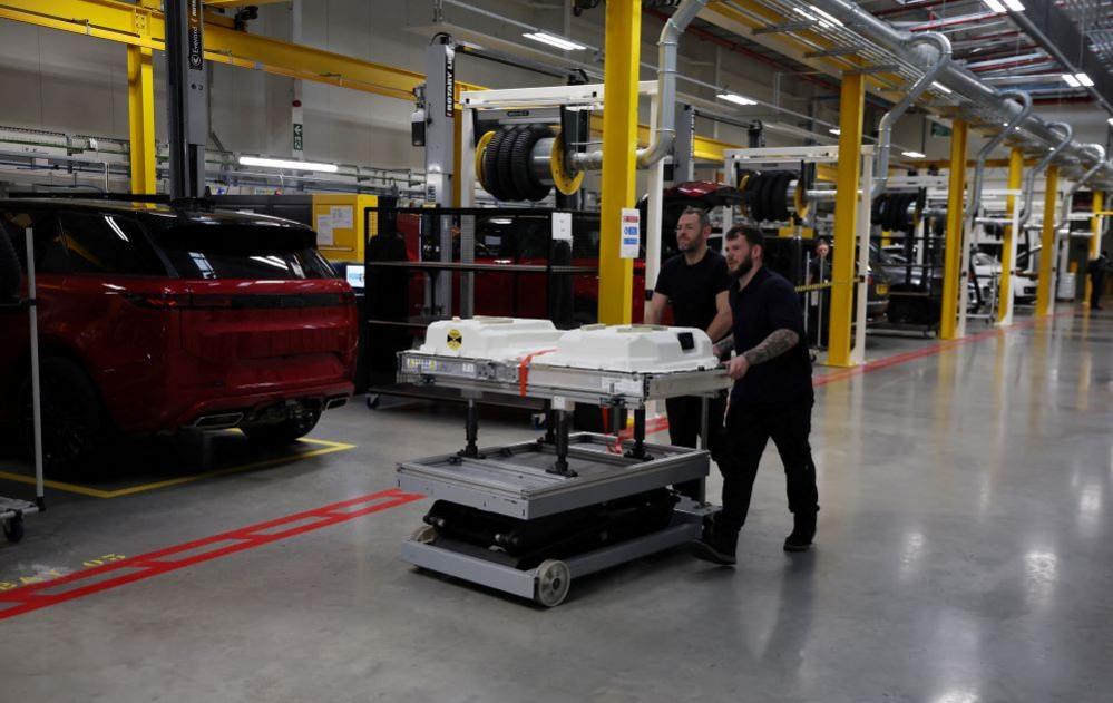 Engineers push a battery unit for a Range Rover PHEV (Plug In Hybrid Electric Vehicle) 