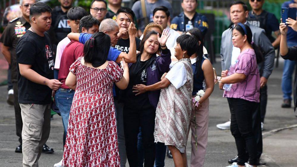 Mary Jane Veloso (C) waves to photographers as she meets her family after arriving at the Correctional Institution for Women in manila on December 18, 2024. 