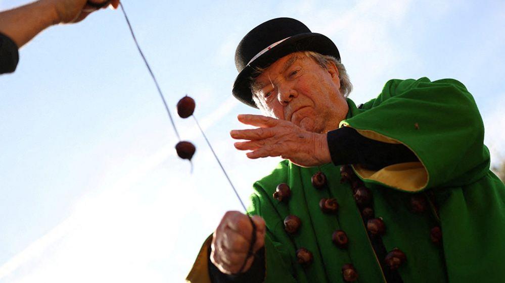 man playing conkers.