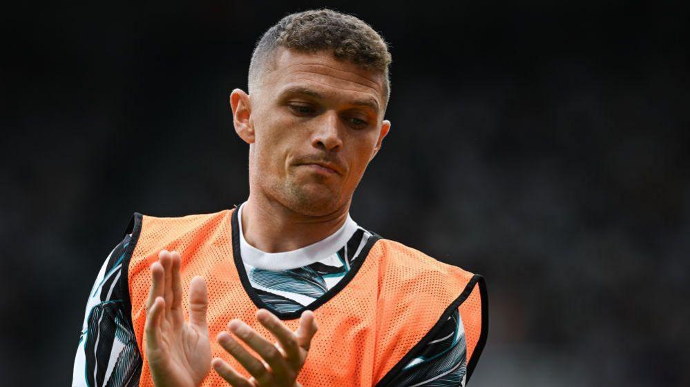 Kieran Trippier claps while wearing a training bib