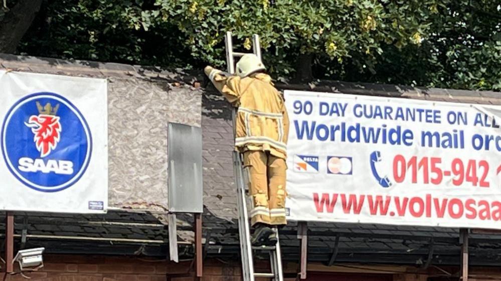 A view looking at the ladder man, taken with a zoomed in camera from the A6514 Western Boulevard.