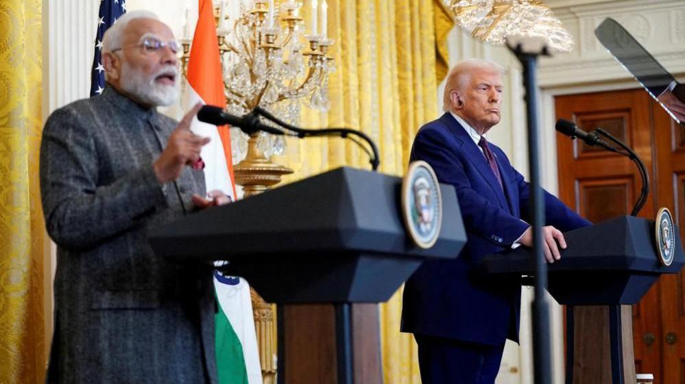 Donald Trump listens as Indian Prime Minister Narendra Modi speaks during a joint press conference at the White House in Washington