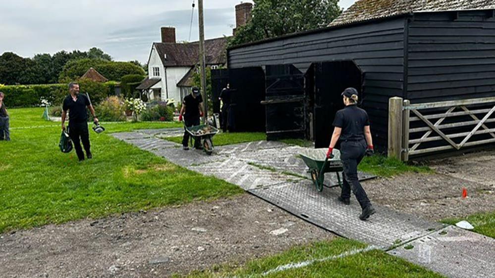 Police searching Stocking Farm, Hertfordshire, looking for the body of Muriel McKay, using wheelbarrows