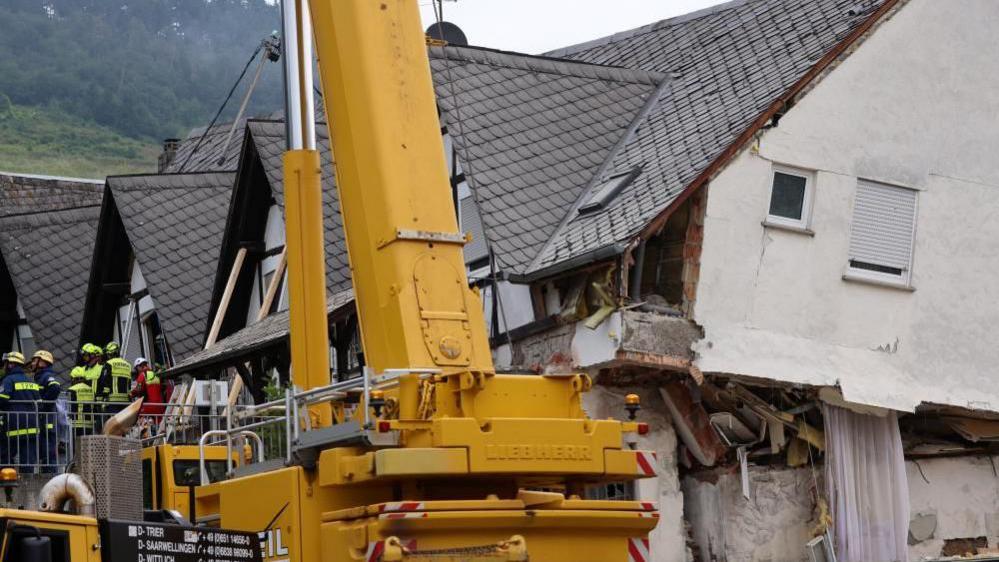 A crane is set up after a hotel partially collapsed overnight near the banks of Germany's river Moselle in Kroev, Germany, August 7, 2024.