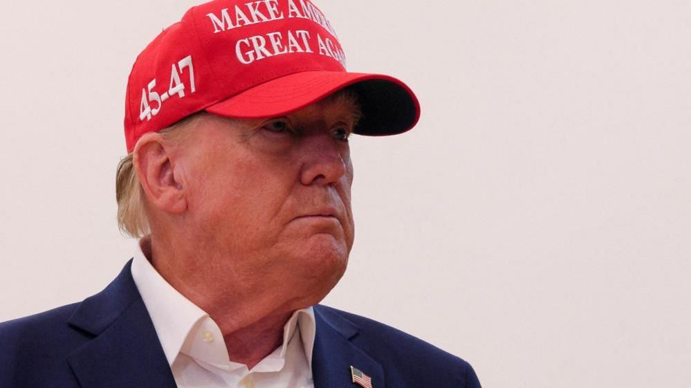 Donald Trump speaks to reporters after voting at Mandel Recreation Center on Election Day in Palm Beach, Florida, 5 November 2024