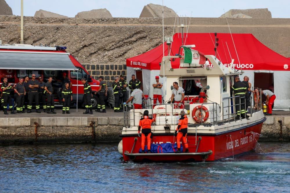 Rescue personnel transport a body bag after a luxury yacht, which was carrying British entrepreneur Mike Lynch, sank off the coast of Porticello, near the Sicilian city of Palermo, Italy, August 21, 2024. 