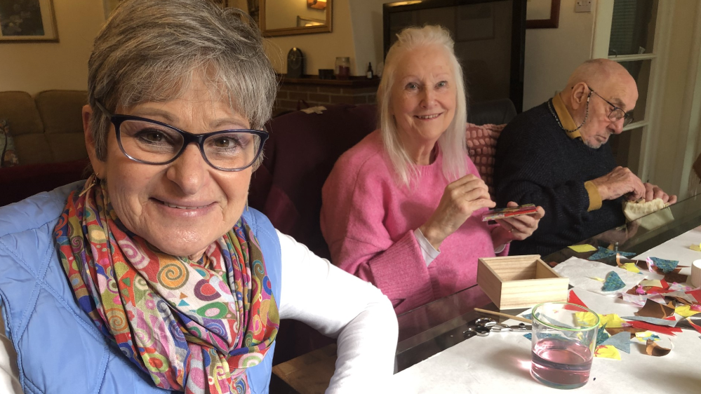 Former Nurse Merle with two other people who both have dementia doing arts and crafts