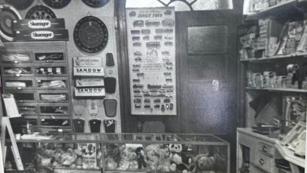 A black and white photo of a toy shop