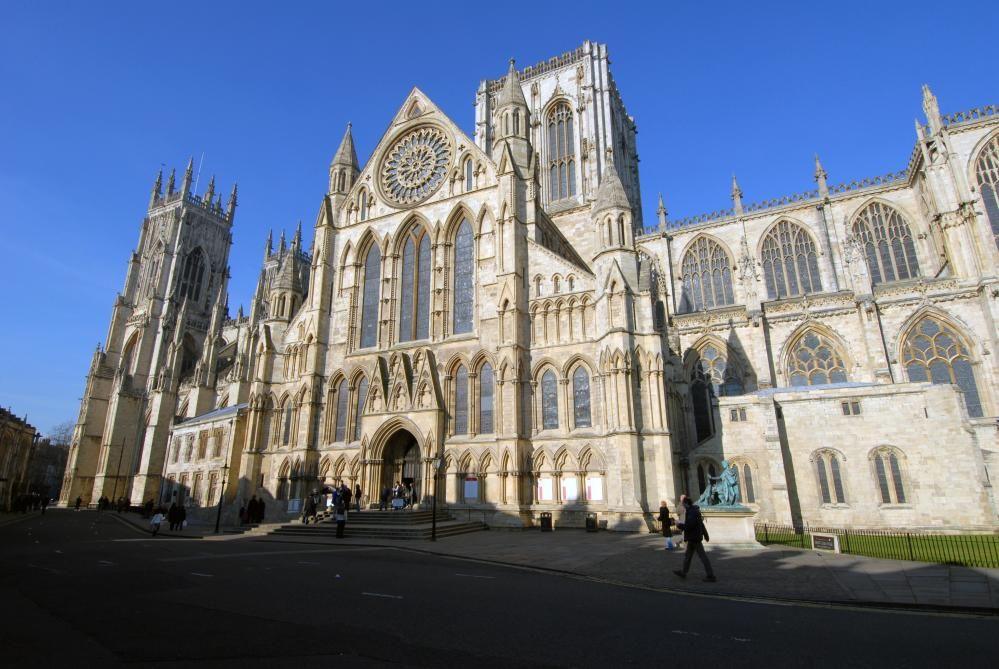 A stock image shows an exterior view of one side of York Minster on a blue day.