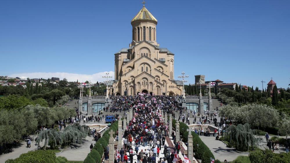 People approach the Holy Trinity Cathedral during a procession, which was organized by the Patriarchate of Georgia's Orthodox Church to mark the Day of Family Purity and Respect for Parents, in Tbilisi, Georgia,