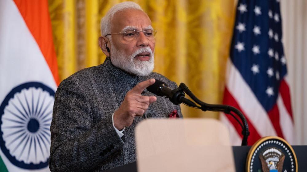 Indian Prime Minister Narendra Modi speaks at a podium at the White House