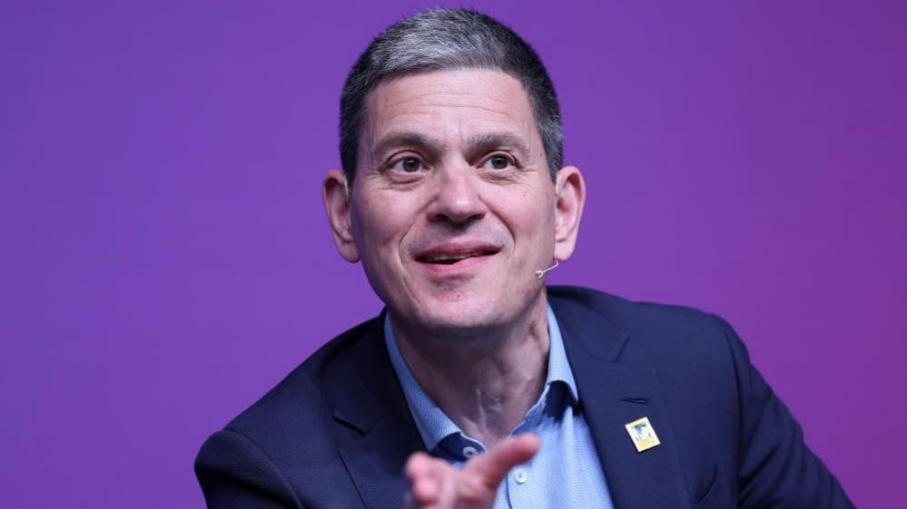 David Miliband speaking on stage