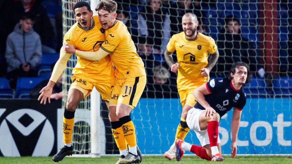 Livingston’s Cristian Montano celebrates with Robbie Fraser